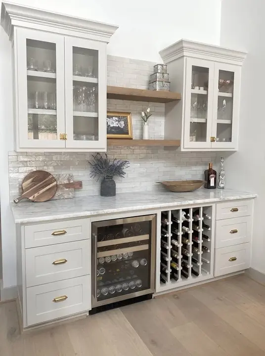 White dry bar with glass-front cabinets, wine fridge and wine rack